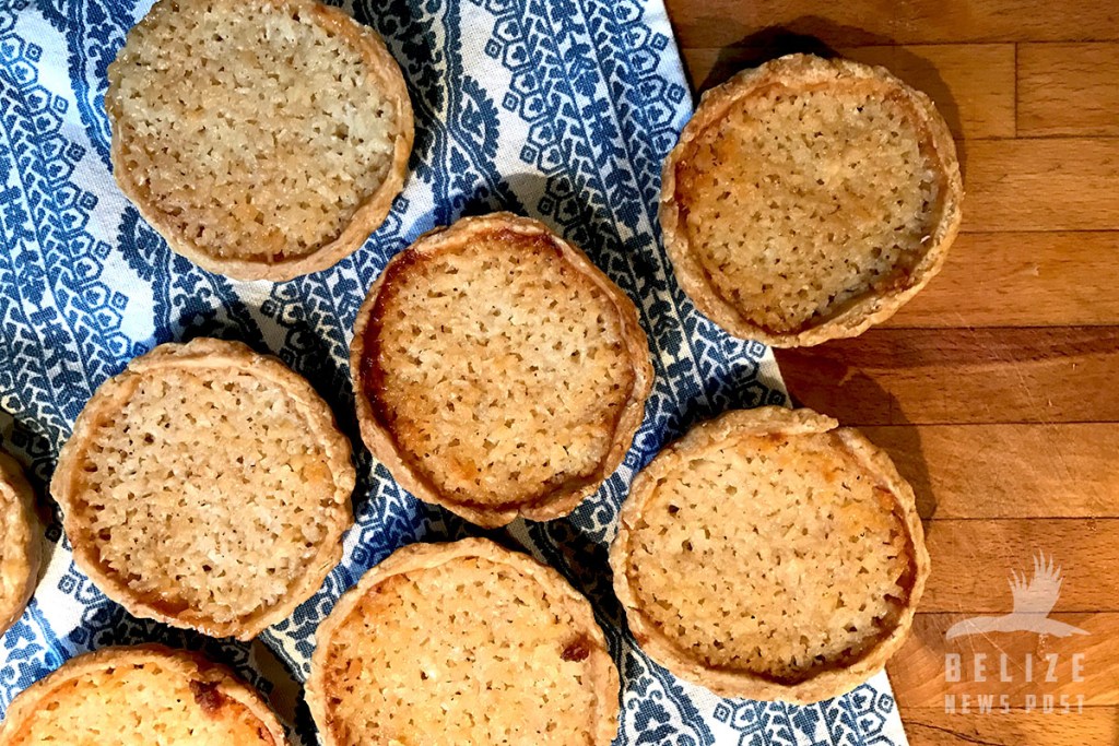 Belizean Coconut Tart Recipe - Freshly Baked Coconut Tarts displayed on a table cloth.