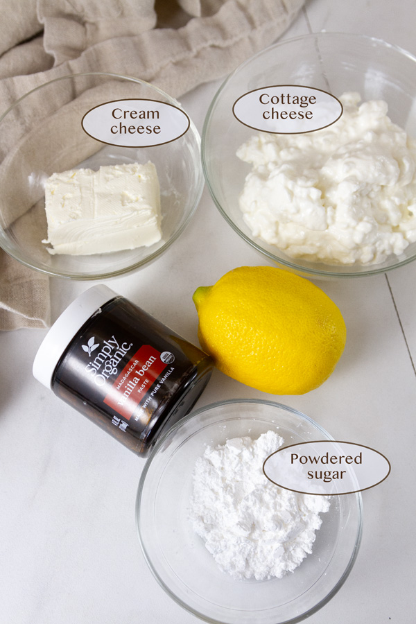 ingredients for lemon pudding: cream cheese, cottage cheese, lemon, sugar, and vanilla.